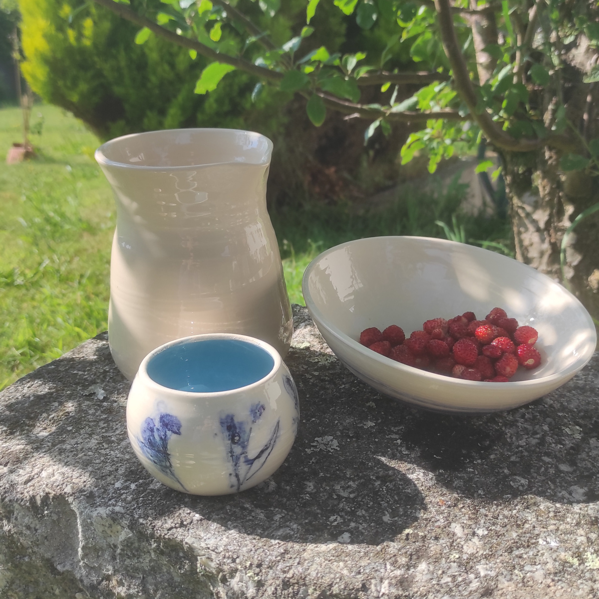 Gobelet rond de la collection fleur et son pichet blanc, saladier spirale avec des fraises.